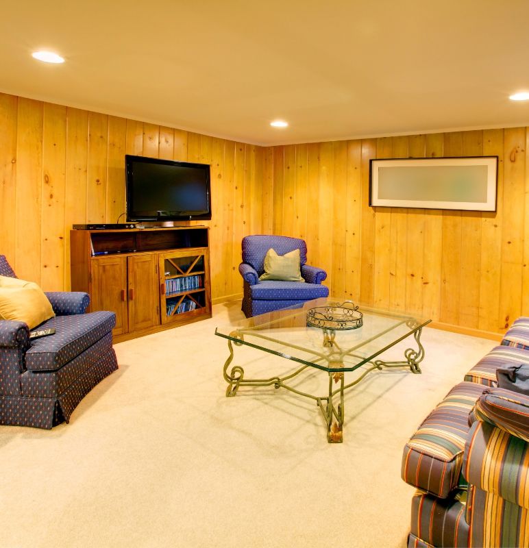 basement family room with blue sofas